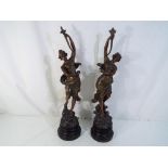 A pair of bronzed spelter figurines approximately 48 cm [h] [2].
