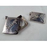 Two sterling silver stamp envelopes, each measuring 3.0 cm x 3.4 cm and 2.3 cm x 3.
