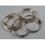 Four pairs of silver earrings. Estimate