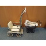 Dolls - A miniature dolls pram with a porcelain Little Heirloom's doll by Valerie Kay and a vintage