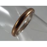 A 9 carat gold and platinum wedding band size J and a half, approximate weight 2.23 grams.