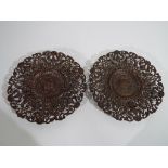 A pair of wrought iron Coalbrook Dale plates with pierced and floral decoration,