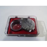 A Triplet 30 mm x 21 mm magnifying eye loupe in presentation case (unused)