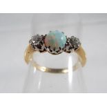 A lady's hallmarked 18 carat yellow gold and platinum three-stone opal and diamond ring, approx 2.