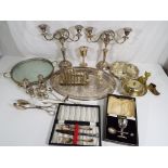 A quantity of silver plated items to include candelabra, cruets, goblet.