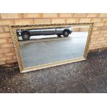A large decorative bevelled edge wall mirror measuring approximately 71 cm x 124 cm.