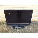 A 32 inches Toshiba LCD TV model #32AV635D with remote control.