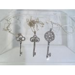 A lot to include three silver key necklaces.