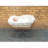 Dolls - A wicker and wrought iron dolls pram with vintage Armand Marseille doll with blue sleeping