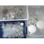 Three boxes of predominantly glassware to include various drinking glasses, candelabra,