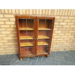 A glass fronted display cabinet, approximately 104 cm x 77 cm x 21 cm.