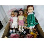 A large collection of mixed dolls to include international costume dolls and six further plastic