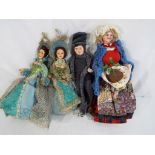 A collection of four papier-mâché stylized dolls in local costumes [4].