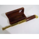 A Past Times telescopic telescope contained in a wooden case with brass detailing.