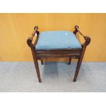 A vintage upholstered piano stool with turned handles approximately 60 cm x 52 cm x 34 cm.