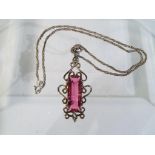 A silver pink stone necklace in box.