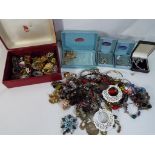 A box containing in excess of 30 predominantly vintage lady's brooches,