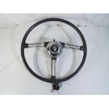A vintage steering wheel off Rover car, Est £40 - £60.