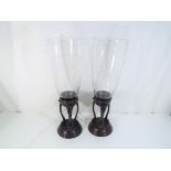A pair of Art Nouveau style metal and glass vases approximately 52 cm [h] [2], Est £30 - £50.
