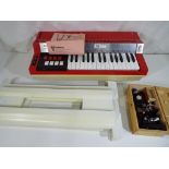 A Bontempi Hit Electric Organ in red with a Kibro microscope in wooden case [4]