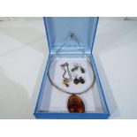 A lot to include two amber necklaces with silver clasps and two pairs of silver setting amber