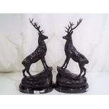 A pair of bronze stags on marble bases,