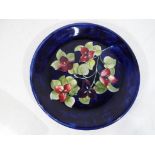 Moorcroft Pottery - a large Moorcroft Pottery platter the Bugainvillea pattern on a blue ground