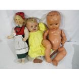 A collection of three vintage dolls consisting of one composition doll with sleeping eyes