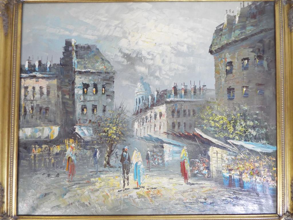 A framed oil on canvas depicting a European street scene, image size approx 49.5 cm x 59.5 cm.