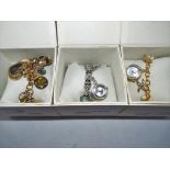Three Lady's evening wrist bracelets - watches with charms, stone set,