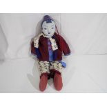 An unusual Japanese doll with ceramic head, soft body,