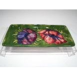 Moorcroft Pottery - A rectangular pen tray by Moorcroft pottery decorated with clematis on a green