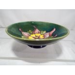 Moorcroft Pottery - a small Moorcroft pottery footed bowl of shallow form,