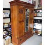 Arts and Crafts - a superior oak wardrobe with carved decoration and mirrored door,