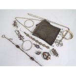 A quantity of predominantly plated items to include a chain purse, bangles, brooches and necklaces,