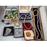 A good mixed lot of vintage costume jewellery to include a plated mourning brooche,