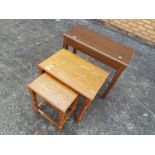 A nest of two table and a veneered table with hinged lid and storage compartment [3].