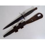 A World War Two third pattern Fairbairn Sykes fighting knife with leather scabbard,