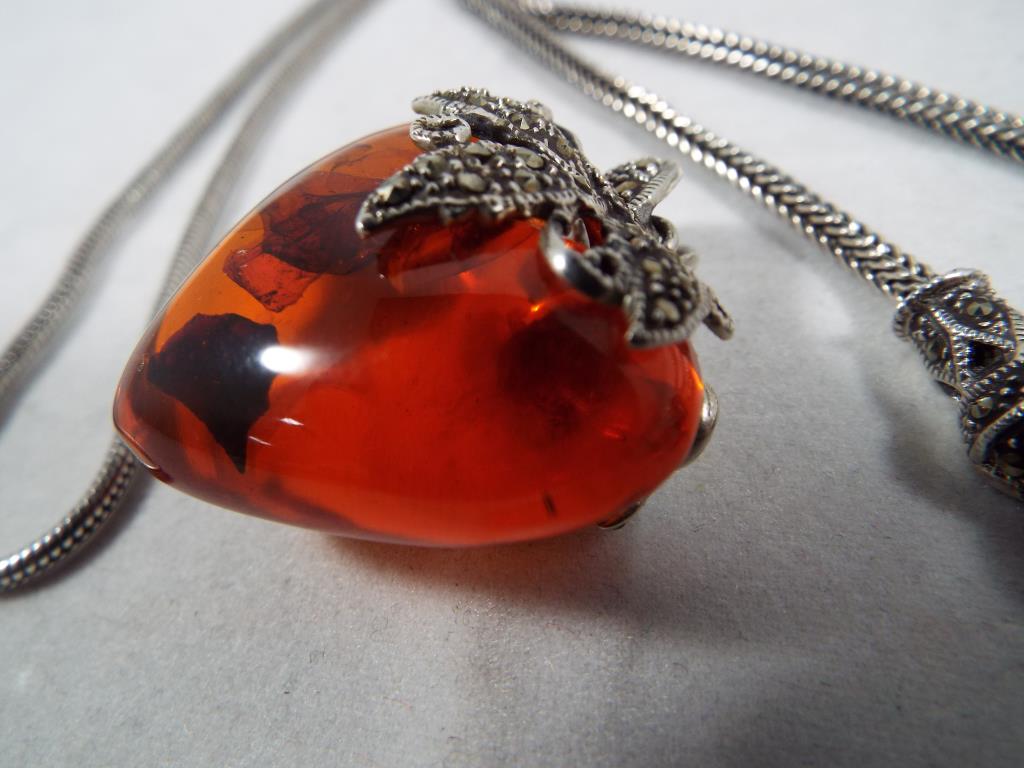 A Lady's white metal and Baltic amber heart shaped pendant set with marcasite with a white metal - Image 2 of 2