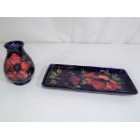 Moorcroft Pottery - a small Moorcroft Pottery vase decorated with anemone on a blue ground