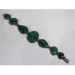 A vintage silver bracelet set with malachite, approximate length including clasp 22 cm,