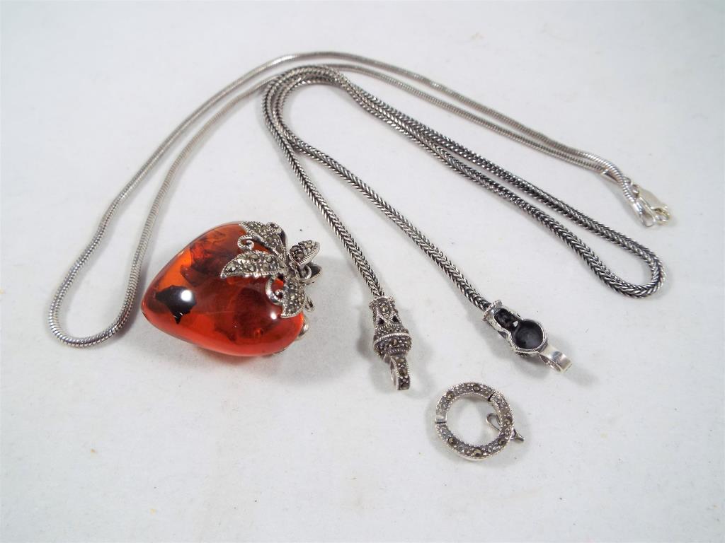 A Lady's white metal and Baltic amber heart shaped pendant set with marcasite with a white metal