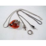 A Lady's white metal and Baltic amber heart shaped pendant set with marcasite with a white metal