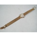 A 9 carat gold lady's Omega wristwatch on a 9 carat gold band, 19mm,