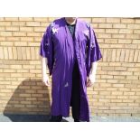 A Japanese silk kimono in purple with detailed floral embroidered approximately 135 cm [L],