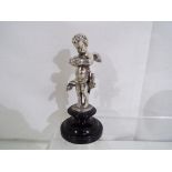 A continental silver cherub on plinth, approximate height 10 cm.