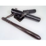 A truncheon with strap, in original leather case, unmarked for any force, has no chips or cracks,