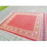 A Bokhara carpet with a red ground,