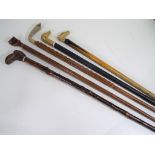 Walking sticks - five walking sticks to include one with carved wooden handle in a form of boot