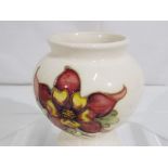 Moorcroft Pottery - a small Moorcroft Pottery vase / urn decorated with columbine on a cream ground,